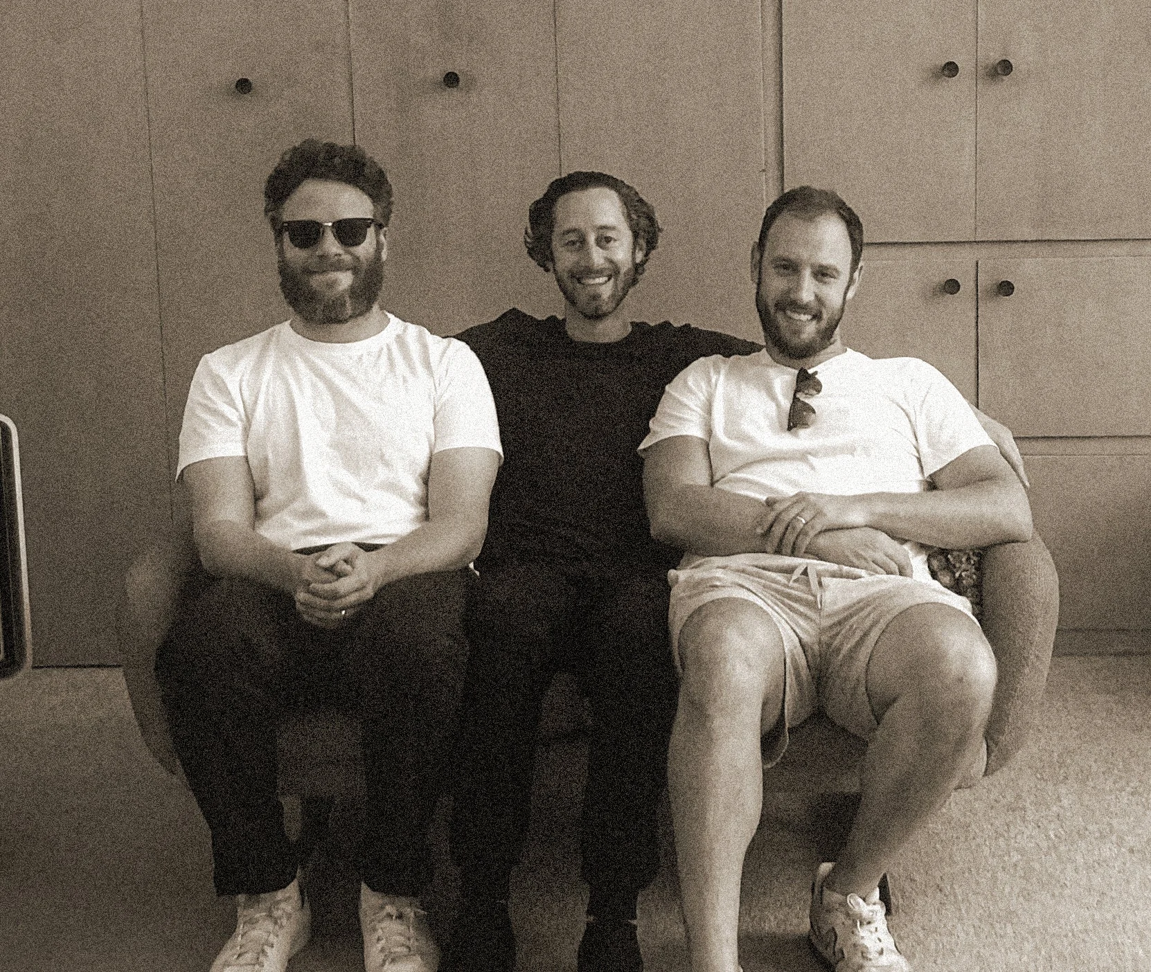 Houseplant founders Seth Rogen, Evan Goldberg and Michael Mohr sitting together on a sofa