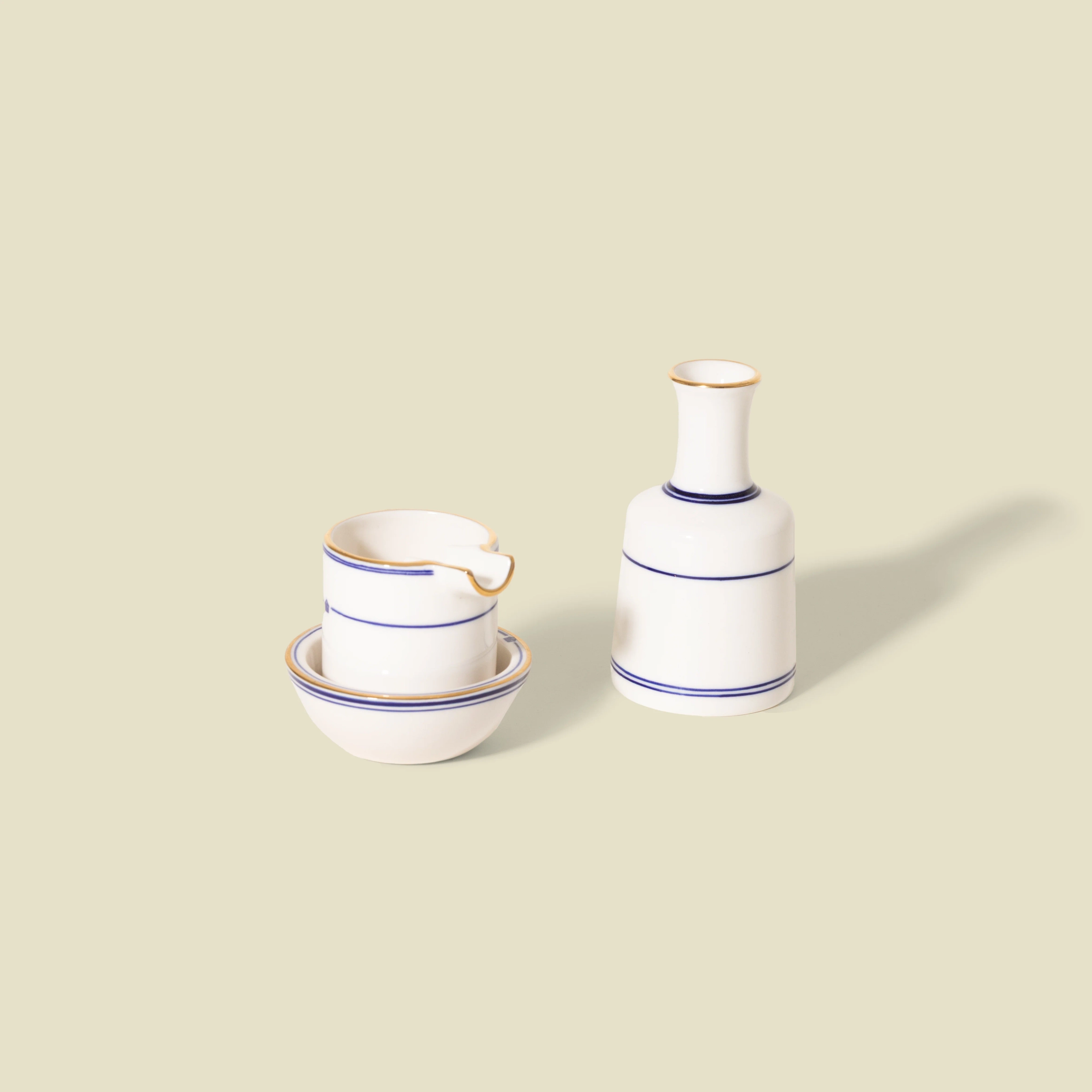 Ashtray Set by Seth: a white ceramic ashtray with blue lines and a matching vase