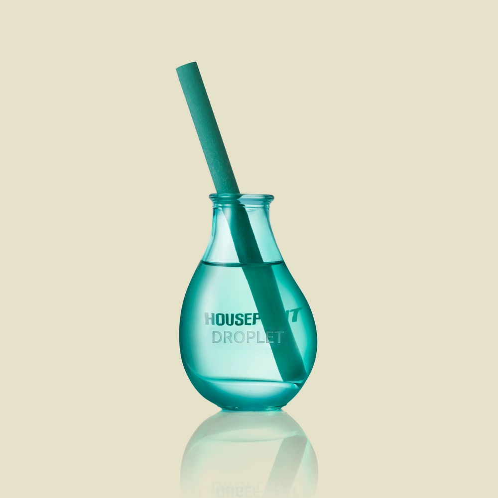 Droplet Reed Diffuser: a teal hand-blown glass droplet with a single turquoise reed