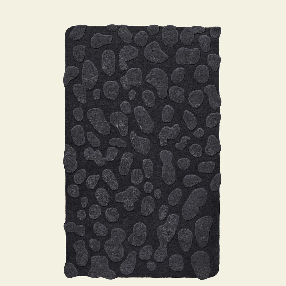 Gloopy Rug in Charcoal: a black rug with raised gloop shapes